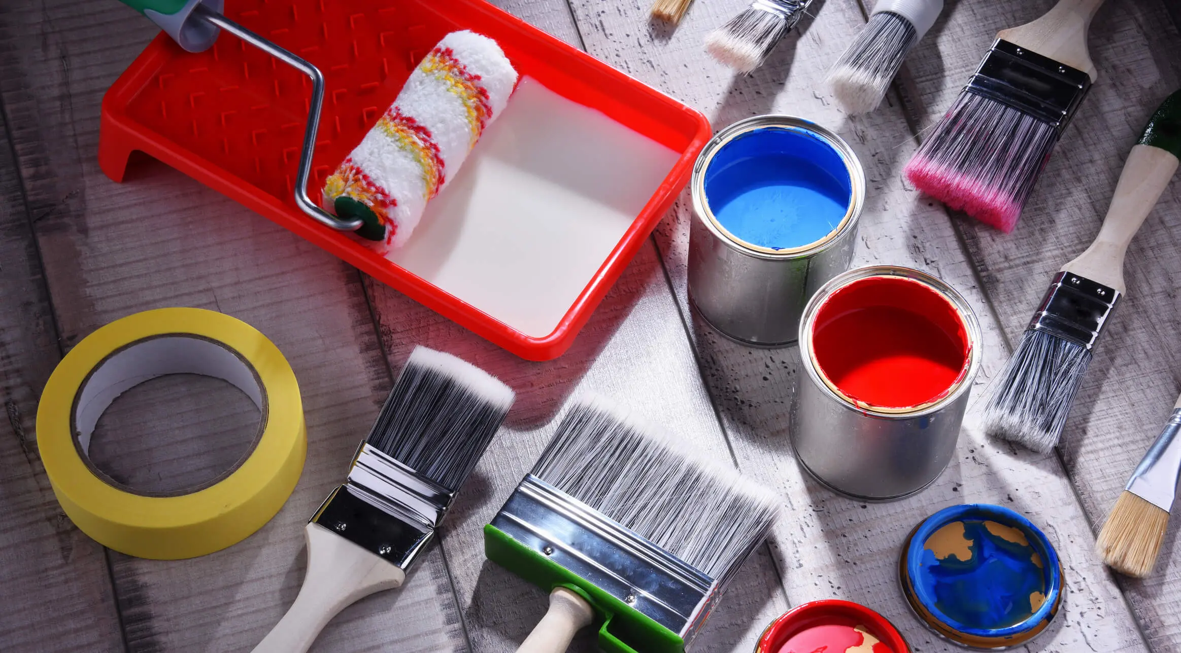 Assorted brushes with red and blue paint